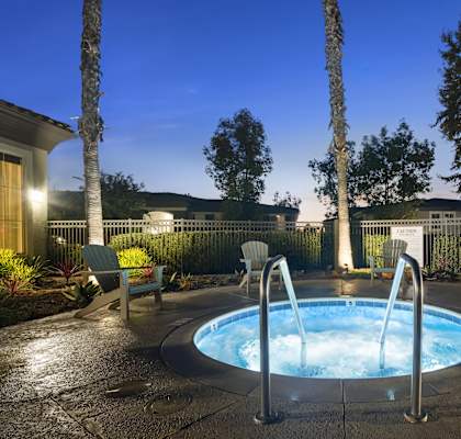 a jacuzzi in the backyard of a house at night