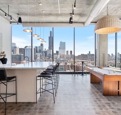 a game room with a pool table and a view of the chicago skyline