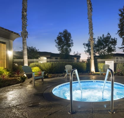 a jacuzzi in the backyard of a house at night