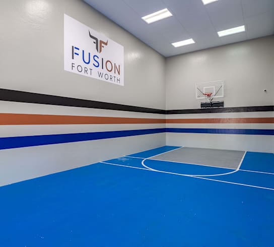 a gym with a basketball court and a fusion for work sign