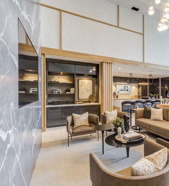 a living room with couches and chairs and a kitchen