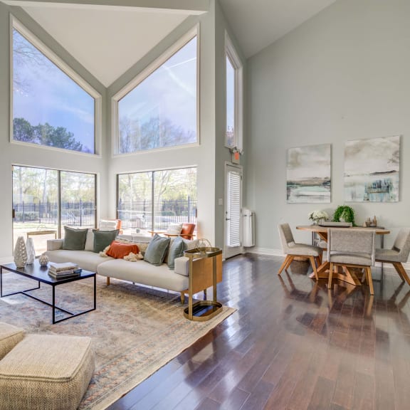 The Pearl at Highland Village Apartments and Townhomes for rent in Jackson, MS photo of a living room with large windows and a couch