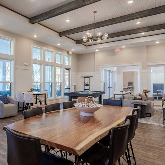 A large dining room with a wooden table and chairs.