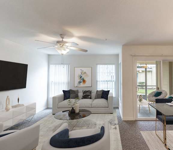 A modern living room with a glass coffee table and a white sofa.