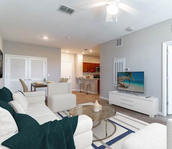 A living room with a white couch and a television.