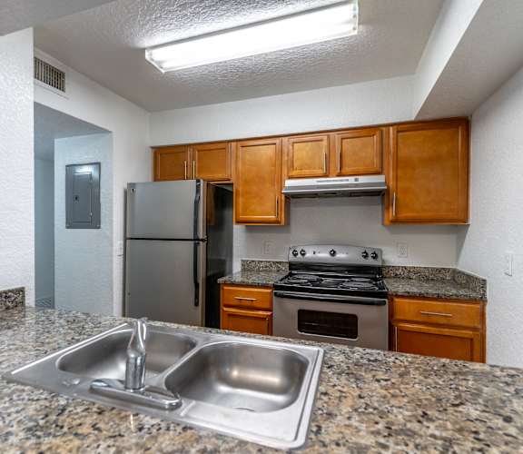a kitchen with granite countertops and stainless steel appliances