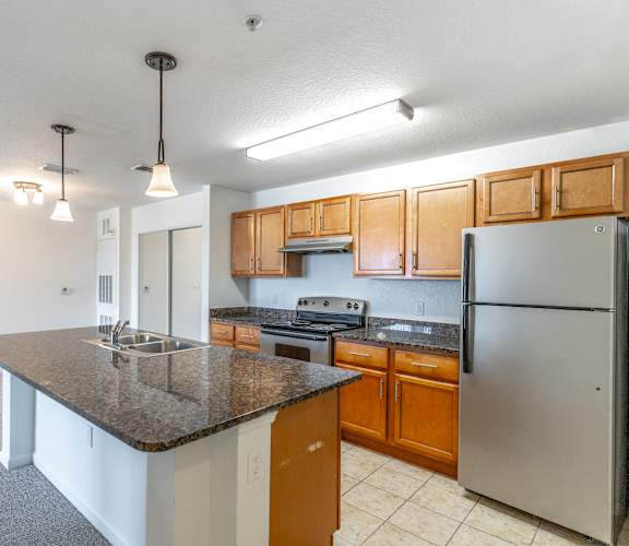 a kitchen with an island and stainless steel appliances