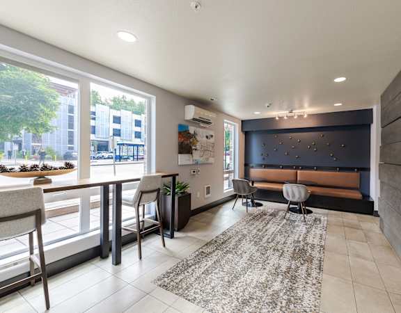 a living room with a tv and a table and chairs