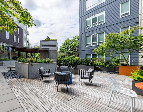 a patio with chairs and a table on a