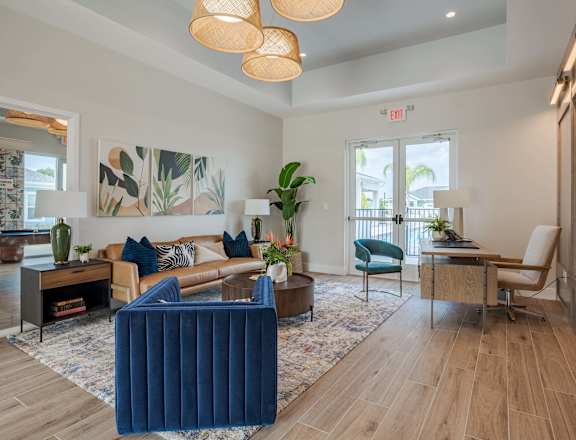 a living room with blue furniture and a door to a balcony