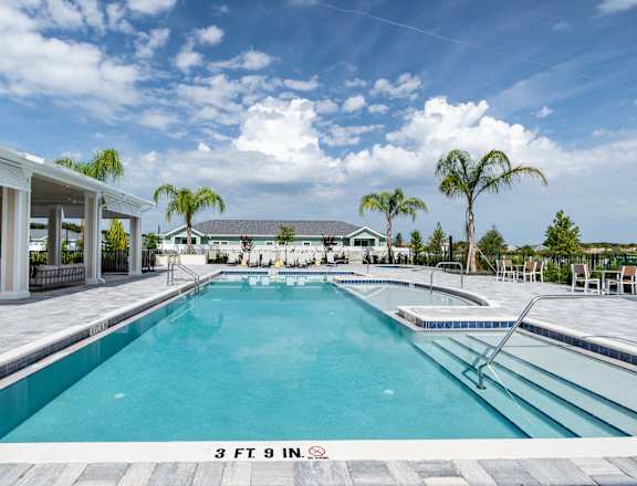a swimming pool at a resort with palm trees