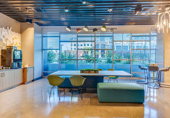 A modern dining area with a long table and chairs.