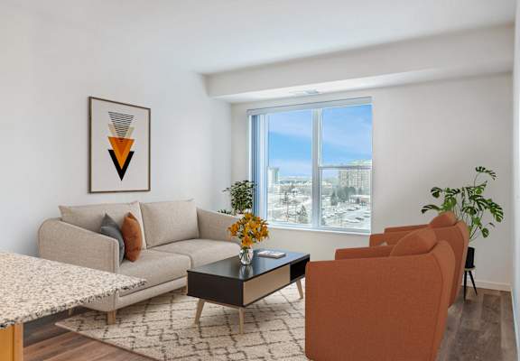 a living room with a couch and a table and a window