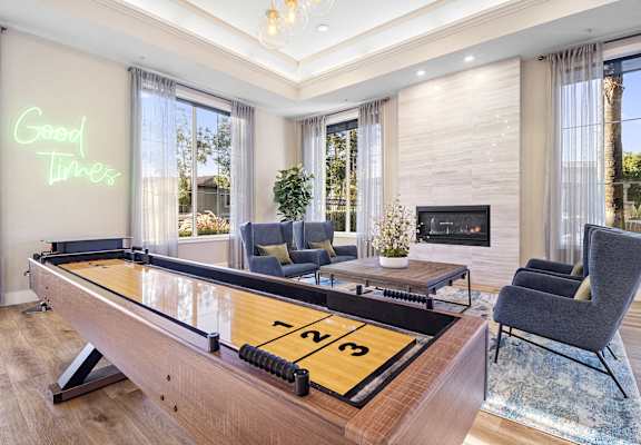 a living room with a pool table and a fireplace
