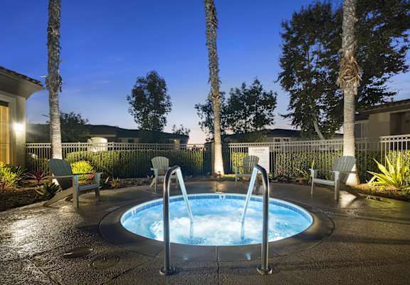 a jacuzzi in the backyard of a house at night