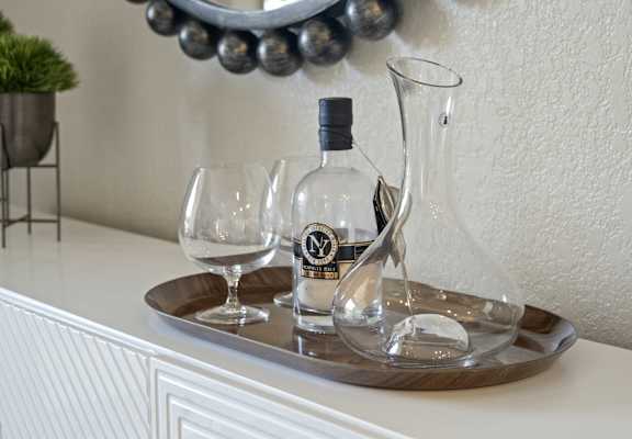 a tray with two wine glasses and a bottle of wine on a table