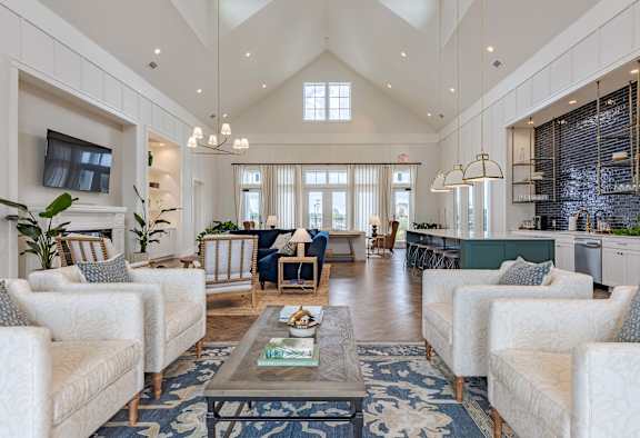 Furnished living room with high ceilings, large window, and stylish decor.