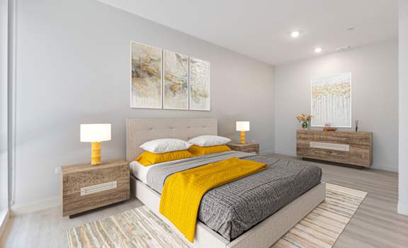 a bedroom with gray walls and a yellow blanket on the bed