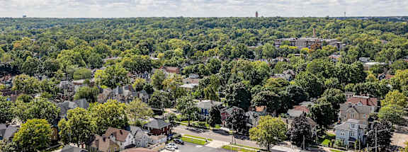 the view of a neighborhood with trees and houses from a window