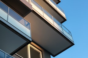 a view of the side of a building against a blue sky