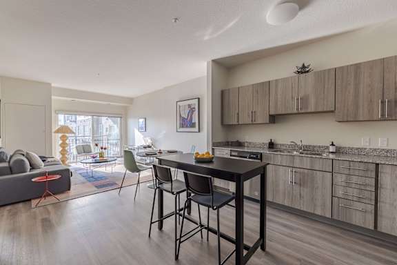 A modern kitchen with a dining table and chairs.