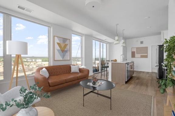 an open living room with a brown couch and a table