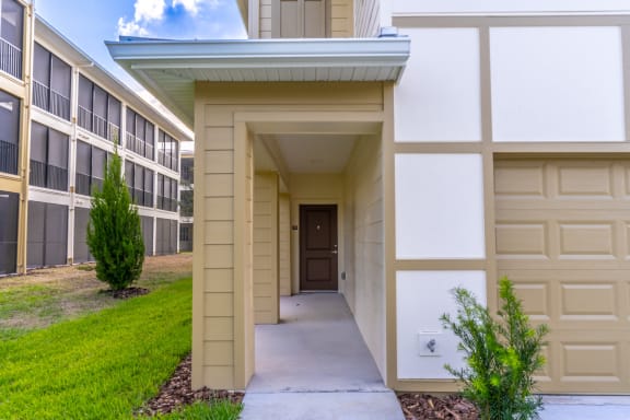 the pathway to the front door of an apartment building