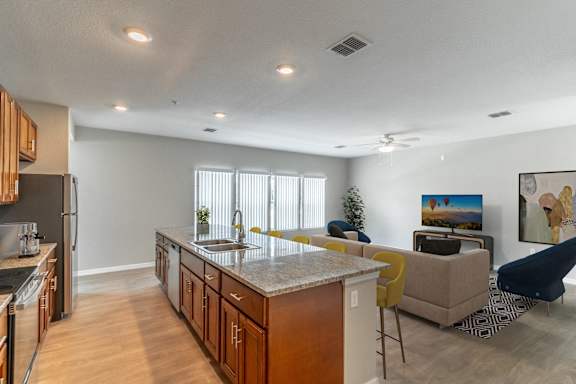 A kitchen with a countertop and a refrigerator.