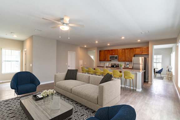 A modern living room with a sofa, armchairs, and a coffee table.