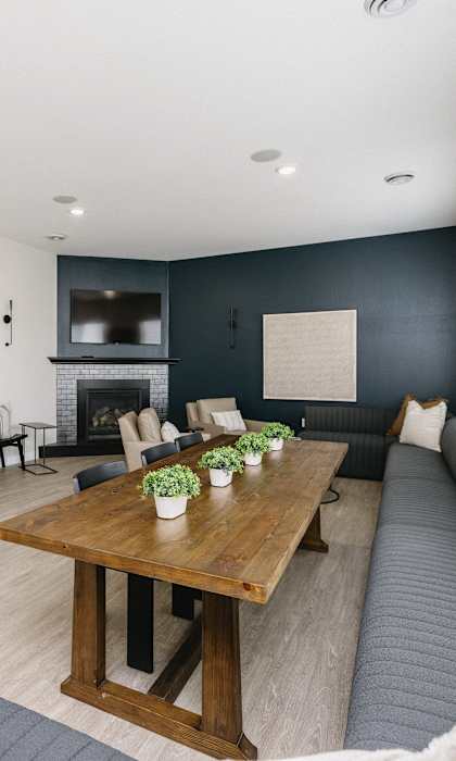 A modern living room with a wooden table and grey couch.