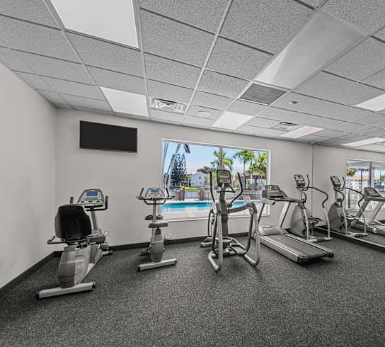 A well-equipped gym with various exercise machines.