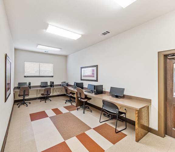 a computer room with desks and chairs in it