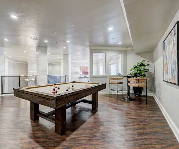 The common area with a pool table at Aviare Arts District Apartments. 