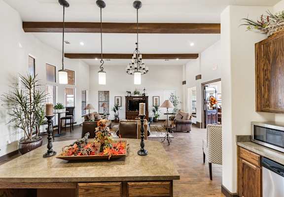 the view of the living room from the kitchen of a home with a large island