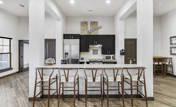 a kitchen with an island with bar stools