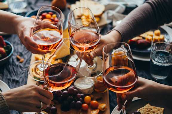 A group of people toasting with glasses of wine.