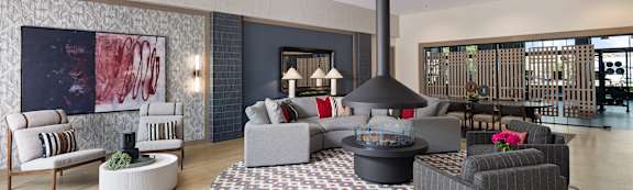 A modern living room with a fireplace and comfortable seating.
