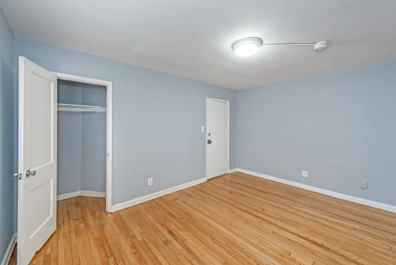 a bedroom with blue walls and a wooden floor