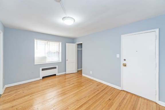 a bedroom with hardwood floors and blue walls