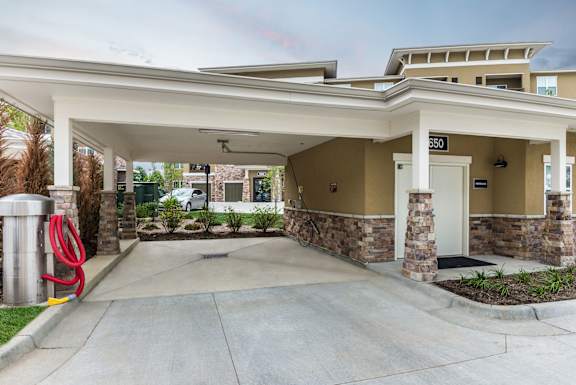 Car care station at Residences at Prairiefire in Overland Park, KS featuring a covered awning, car vacuum, and sprayer arm for residents. at Residences at Prairiefire Apartment Homes, Kansas, 66223