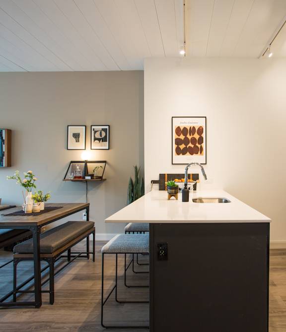 A modern kitchen with a dining table and chairs.