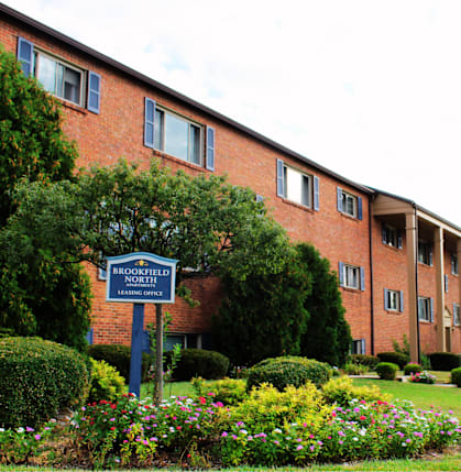 a large brick building with a sign in front of it