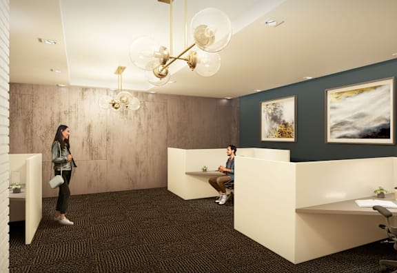 Two people are sitting in a room with a white ceiling and a chandelier.