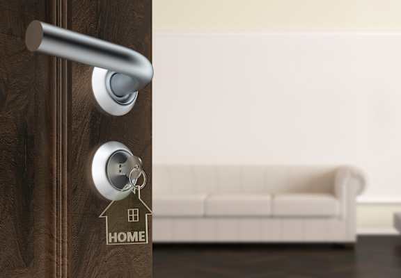 a door with a house key on the door handle