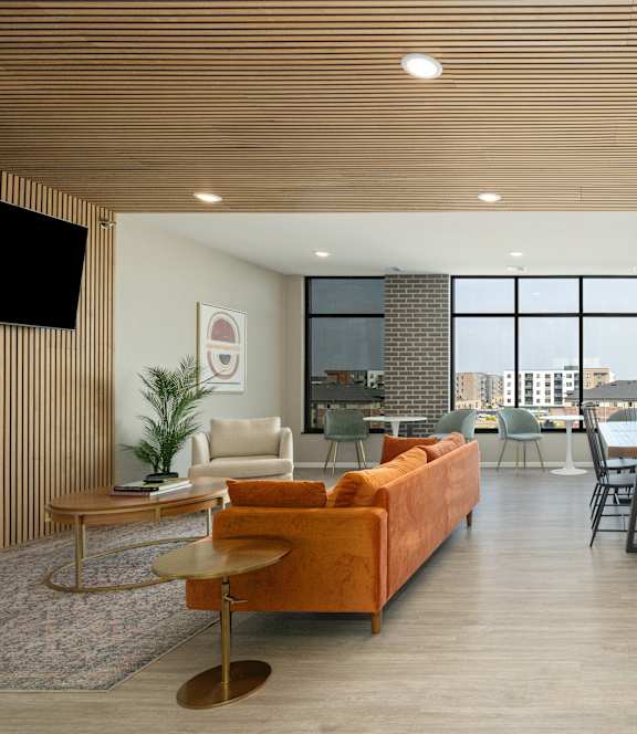 A modern living room with a large window overlooking the city.