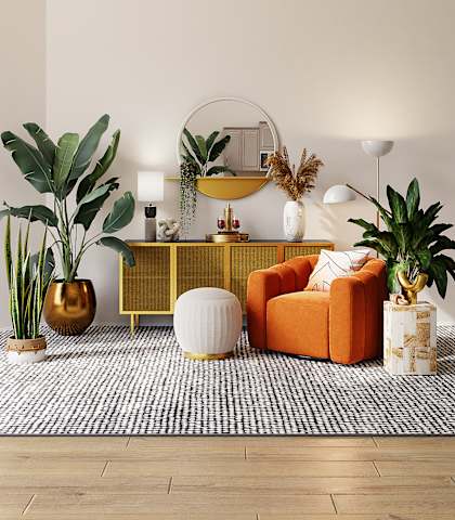 a living room with an orange couch and a yellow sideboard with a round mirror on top