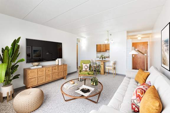 a living room with a white couch and a green chair