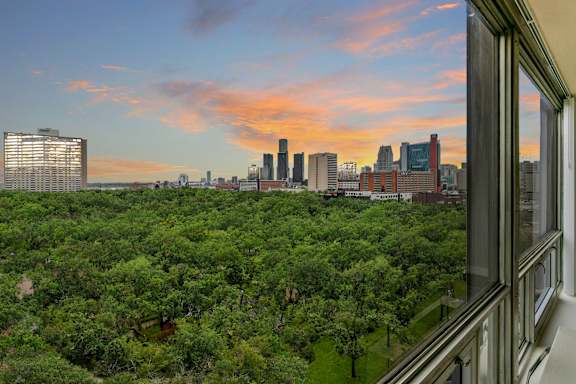 A city skyline is visible from a high vantage point.