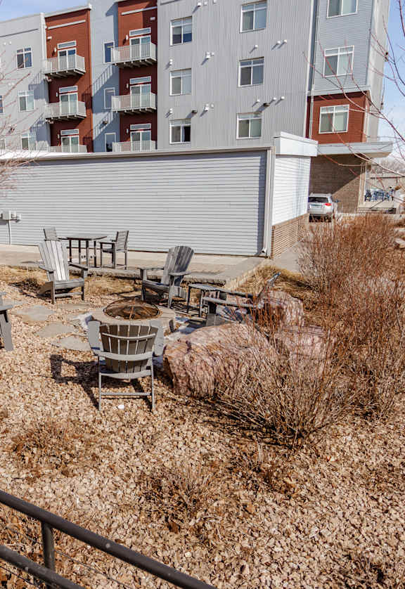 A backyard with a fence and a small table and chairs set.