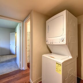 a laundry room with a washer and dryer in a house